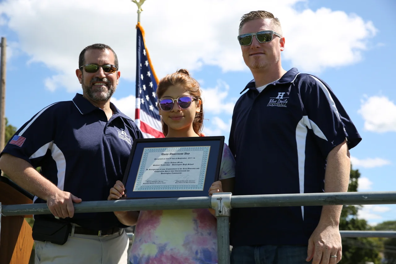   "Excellence in Student Leadership" awardee and Huntington High School student Emily Andrea Miron receives her award from Superintendent James Polansky, left, and Principal Brenden Cusack.  &nbsp;Photo by Steve Bartholomew  