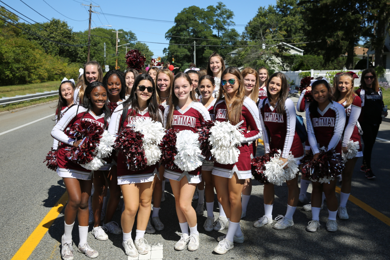   Walt Whitman high school cheerleaders stop for a picture along the parade route.&nbsp;  Photo by Steve Bartholomew  