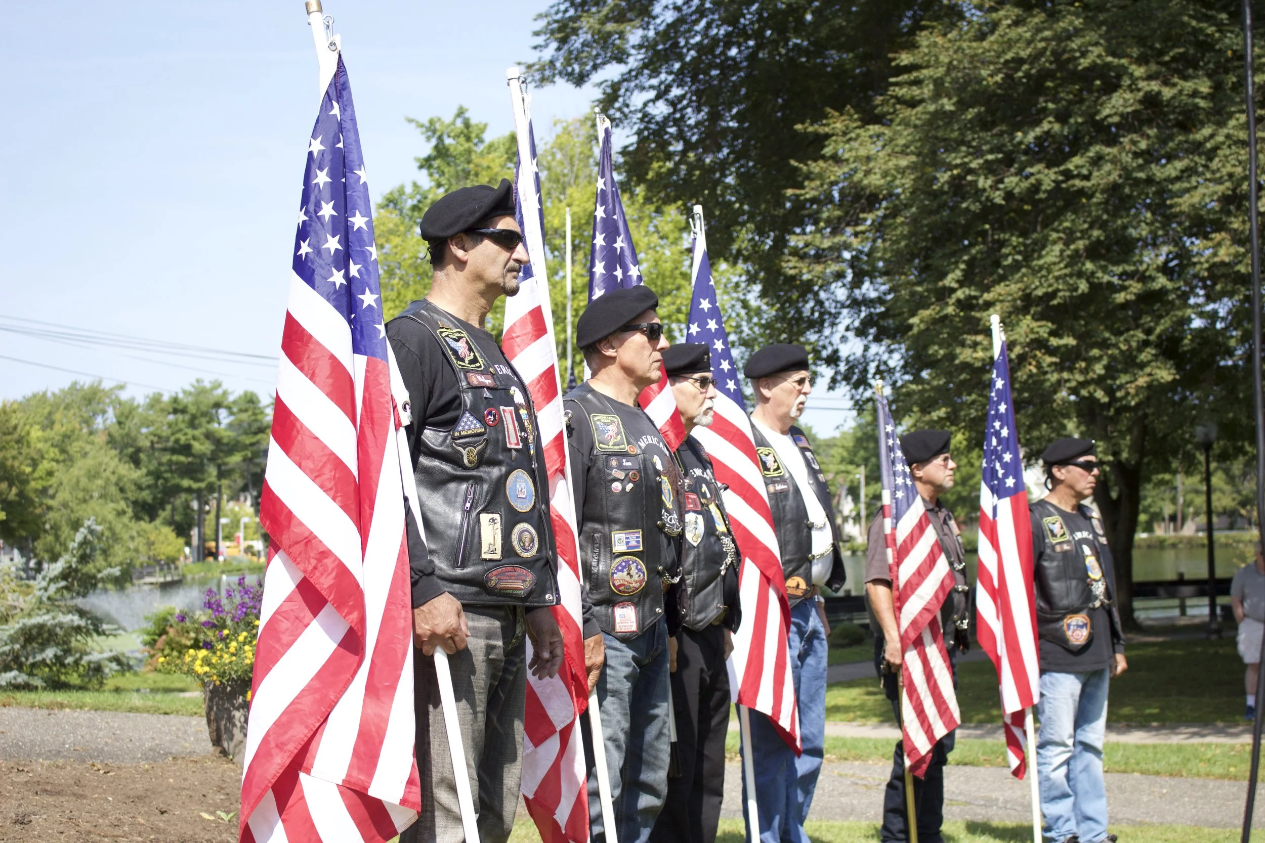   Members of the American Legion Greenlawn Post 1244 Riders hold the American flag during the reading of names.   Long Islander News photos/Janee Law  