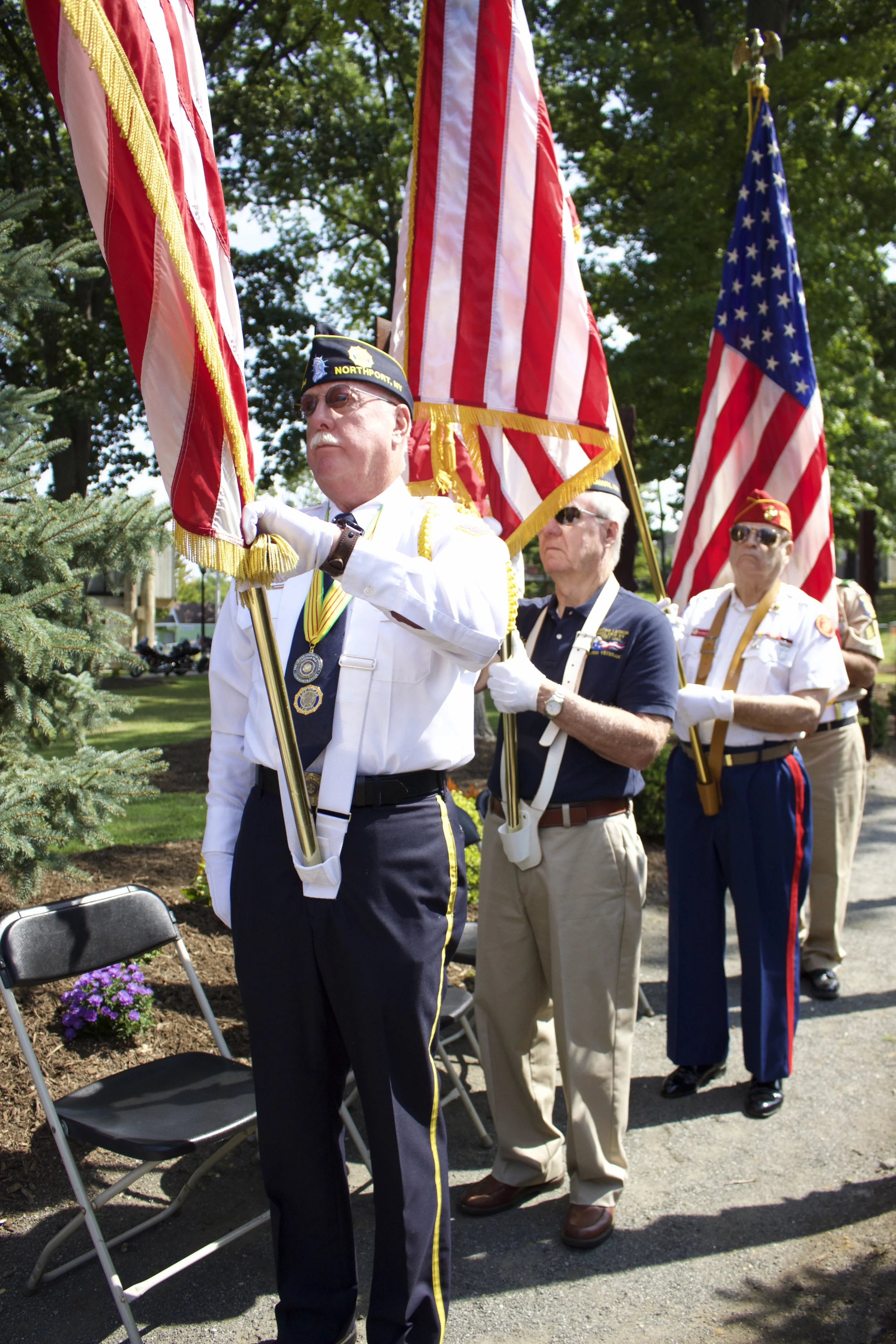   Veterans hold American flags in the memorial walkway during the reading of names.   Long Islander News photos/Janee Law  
