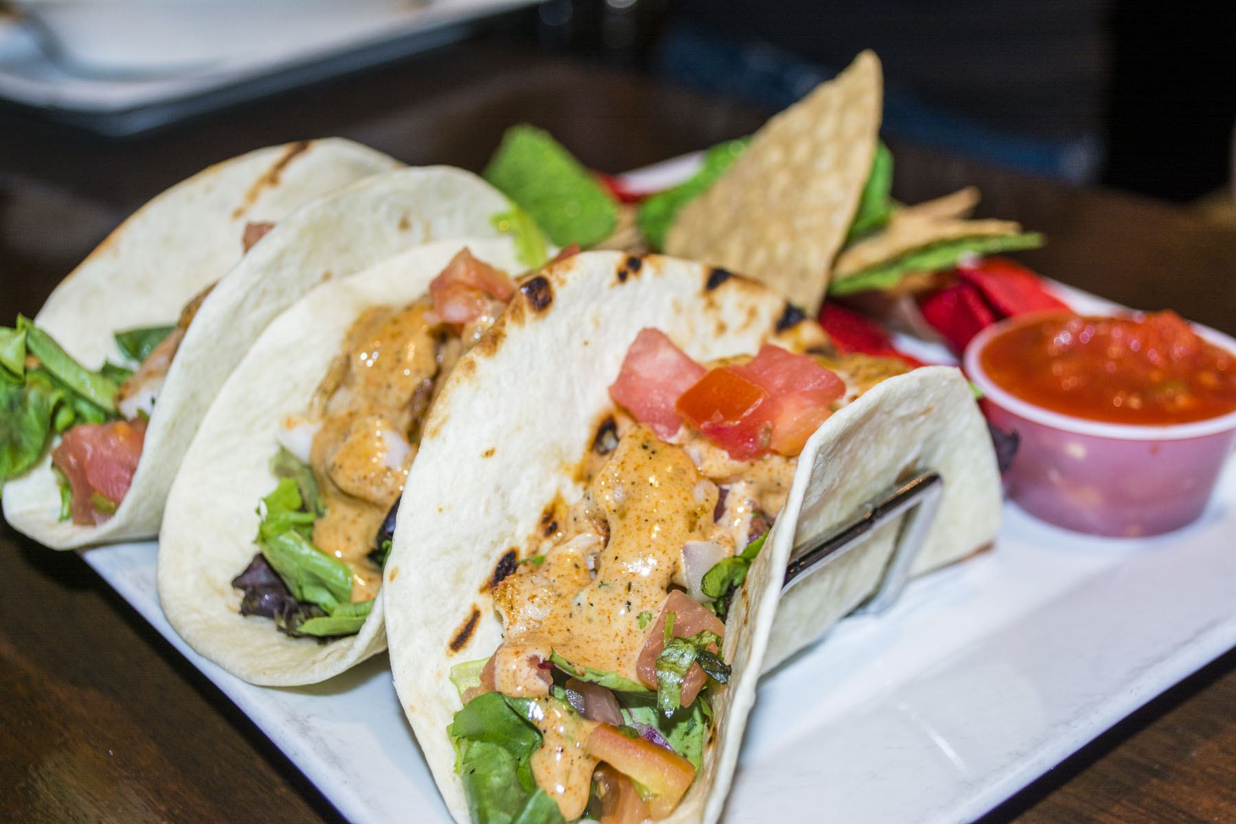   The Shrimp Tacos ($12) feature seasoned grilled shrimp, lettuce, and pico de gallo wrapped in three soft shell tacos.  