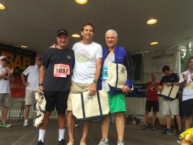   Marc Krieg, Bill Oehrlein, and Jerry Asher have been running the Great Cow Harbor 10K Run since its inception in 1977.     Photo courtesy of Hon. Jerry Asher     