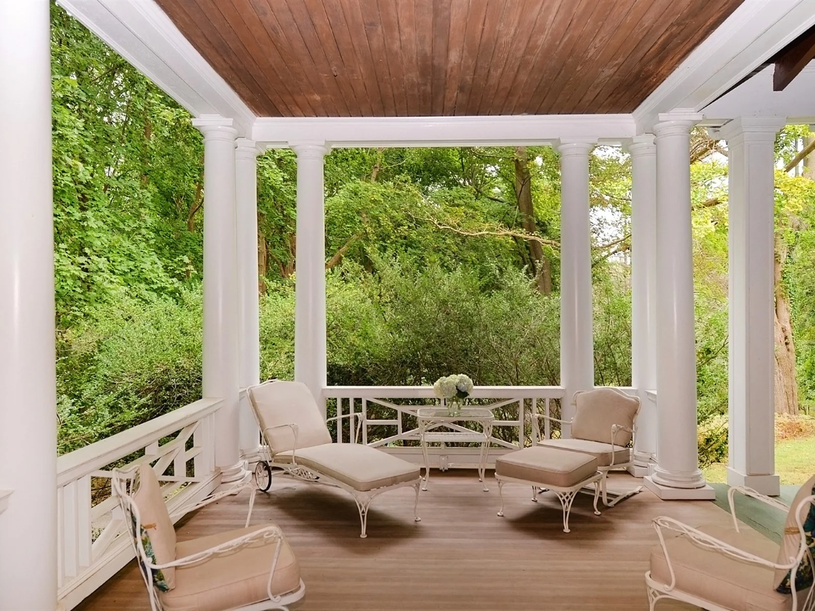   There are four porches with panoramic views of the property’s 27.62-acres.   Photo Courtesy of Douglas Elliman Real Estate  