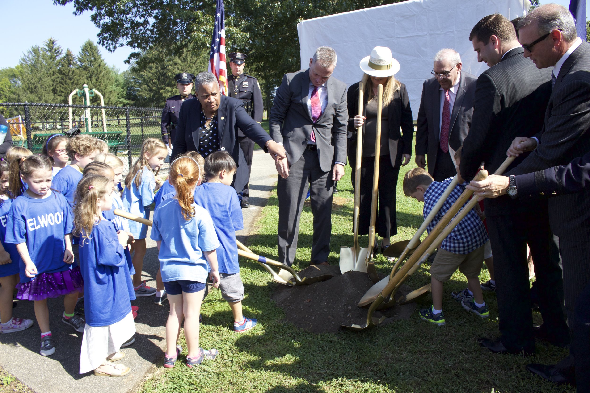   Austin Tuozzolo, right, with local officials and children in his kindergarten class break ground on the town’s first spray park, which has been dedicated to his father the late NYPD Sgt. Paul Tuozzolo.   Long Islander News photo/Janee Law  