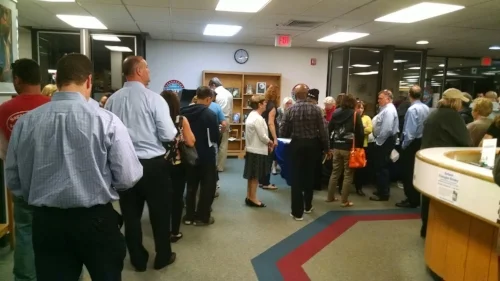 Members of the Dix Hills community lined up at the Half Hollow Hills Community Library on Tuesday to vote on the $14.5 million bond for the library’s new construction project. Photo by Steve Silverman