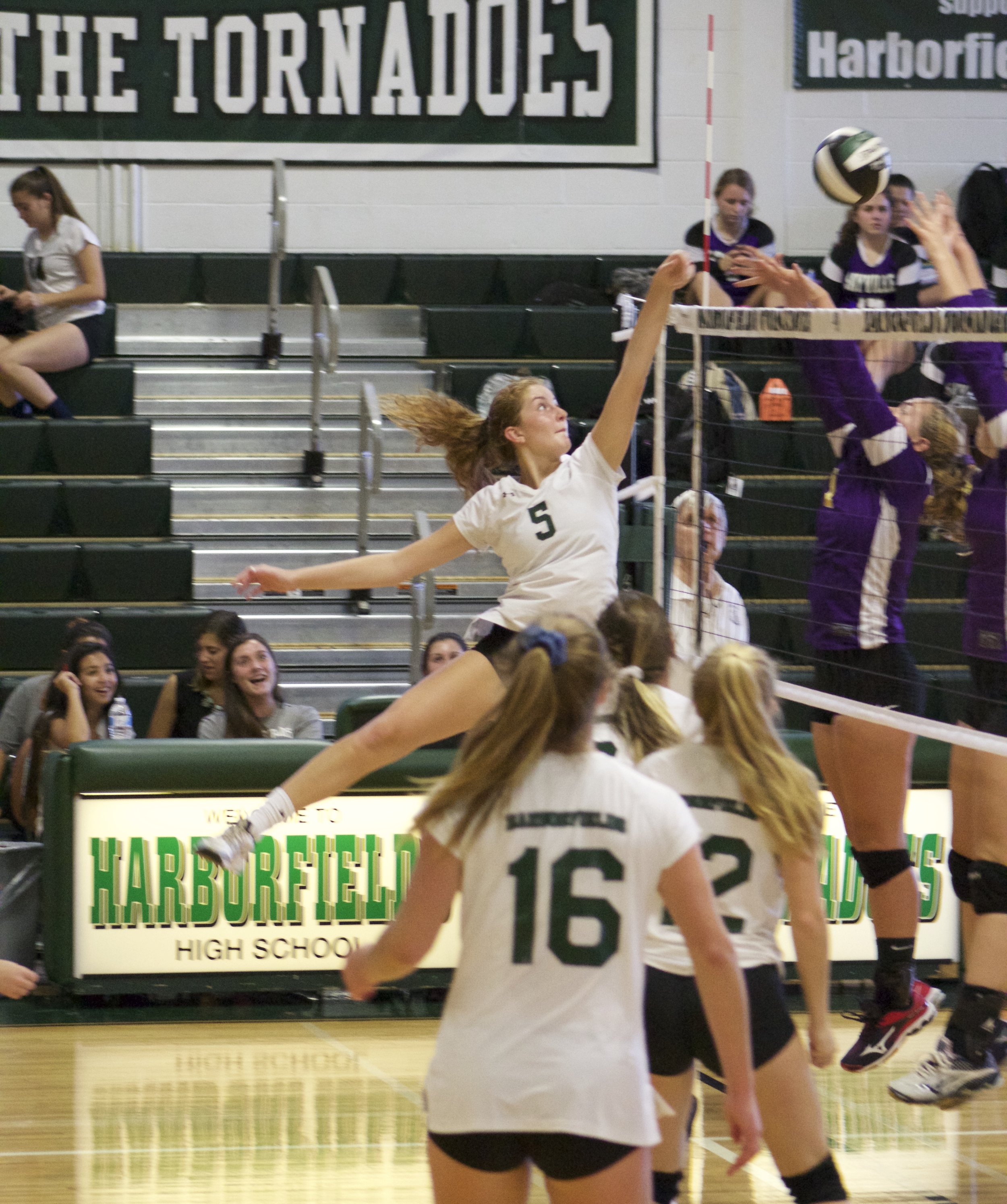   Alex Madden (no. 5) taps the ball over the net during the Harborfields girls volleyball non-league game against Sayville.   Long Islander News Photo/Janee Law  