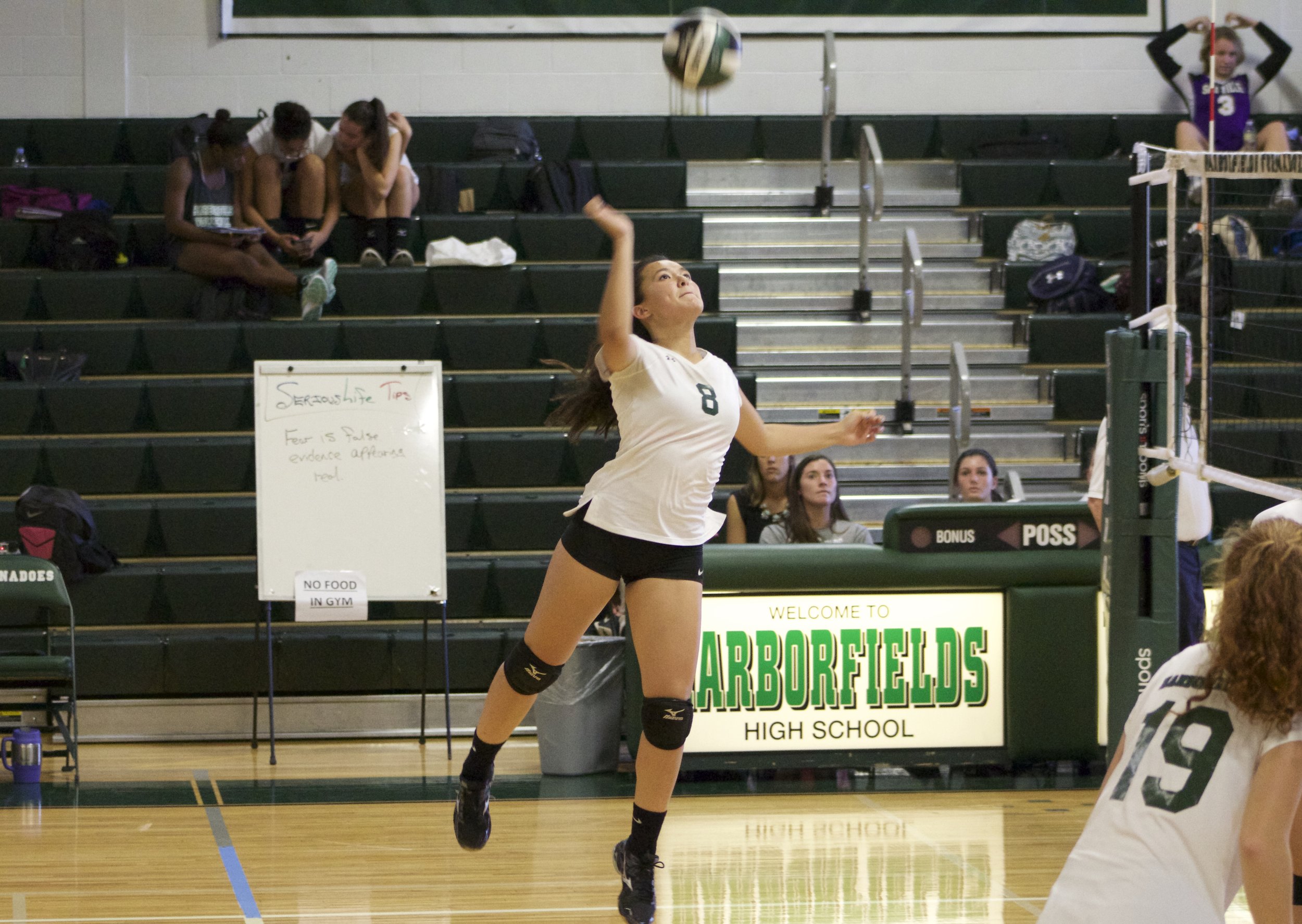   Senior outside hitter Bella Carr (no. 8) jumps to hit the ball over the net.   Long Islander News Photo/Janee Law  