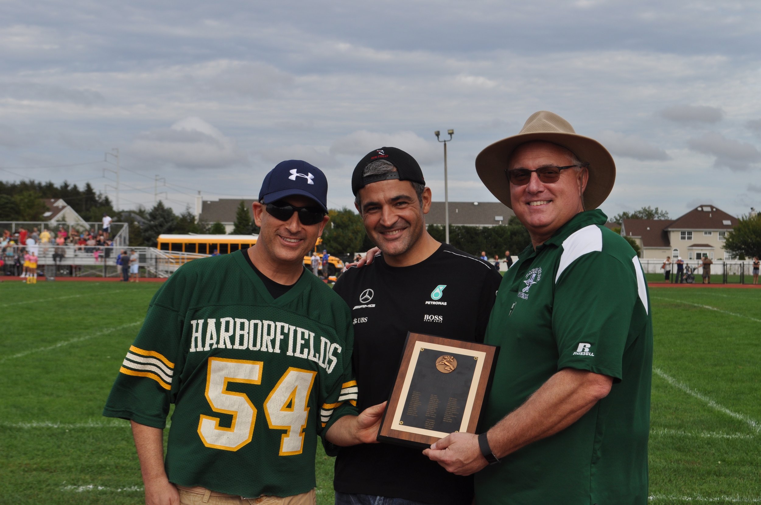   Members of the Harborfields High School Class of 1987 presented the school with the football team’s 1987 Division V League Championship plaque at Saturday’s football game.   Photo Courtesy of John Tilden  