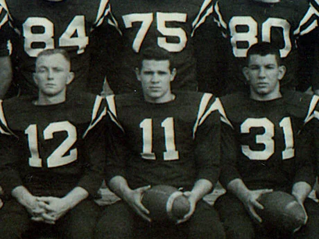   Hon. W. Gerard “Jerry” Asher, center, is pictured during his senior year campaign as Huntington football captain and quarterback.  