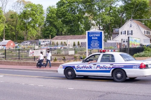 A Suffolk police vehicle is pictured driving past Gateway Park in Huntington Station. Long Islander News Photo/Archives