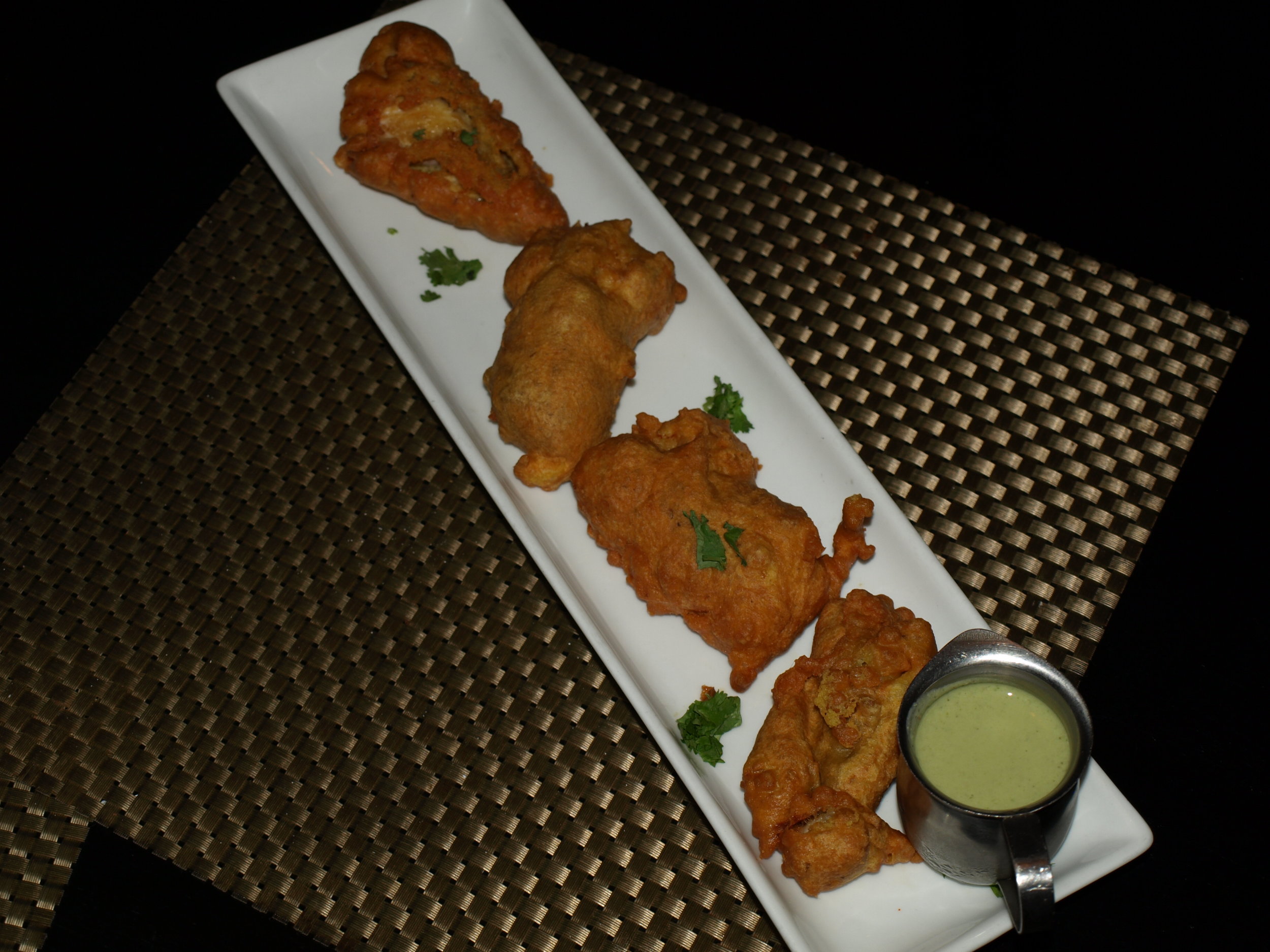   The Bombay Fritters ($12) are fish fried in a chickpea batter served with a mint and green chili chutney sauce.   Long Islander News Photo/Connor Beach  