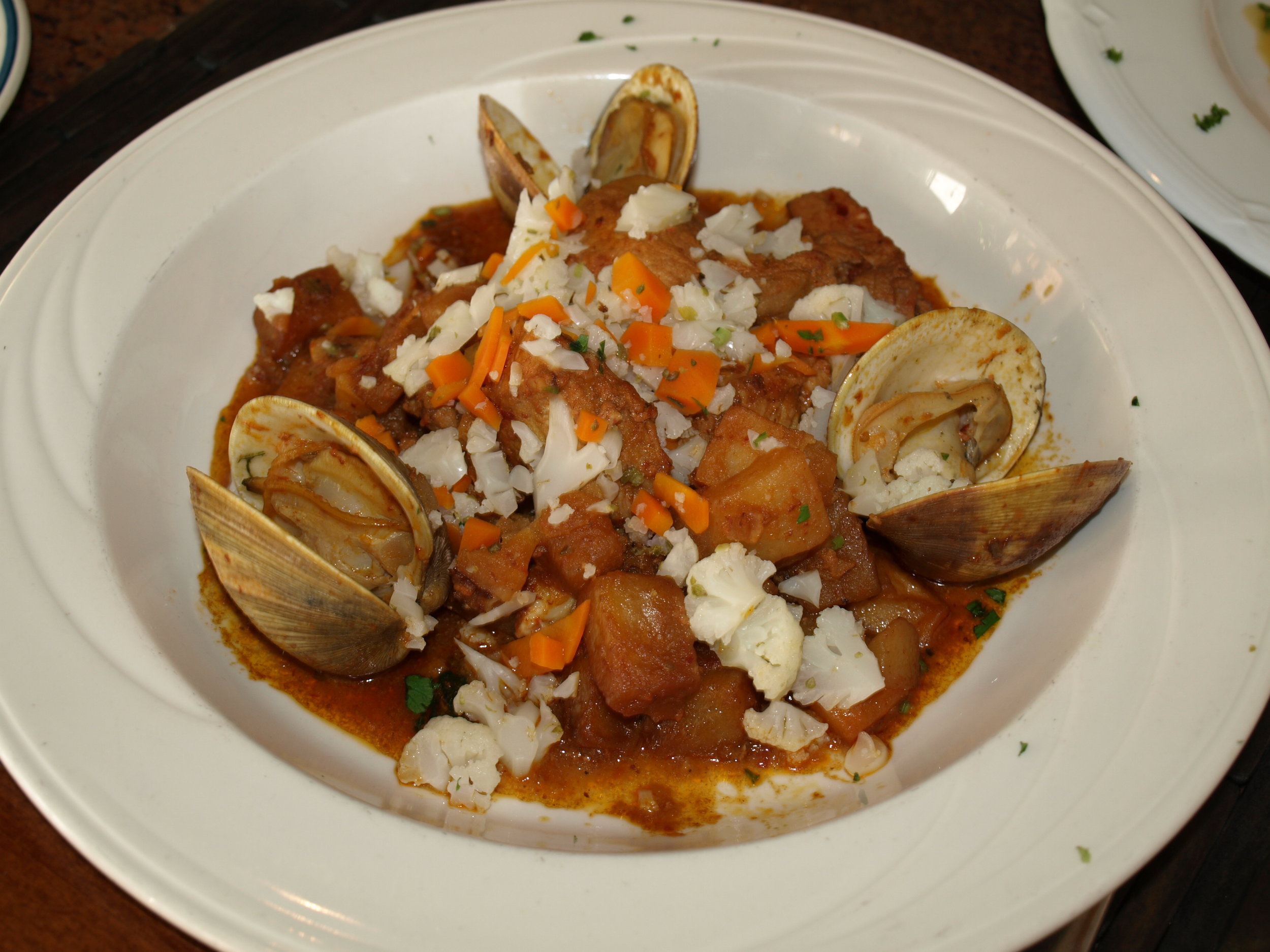   The Carne de Porco a Alentejana ($29) includes pork and whole clams stewed with potatoes and a roasted red pepper puree.   Long Islander News Photo/Connor Beach  