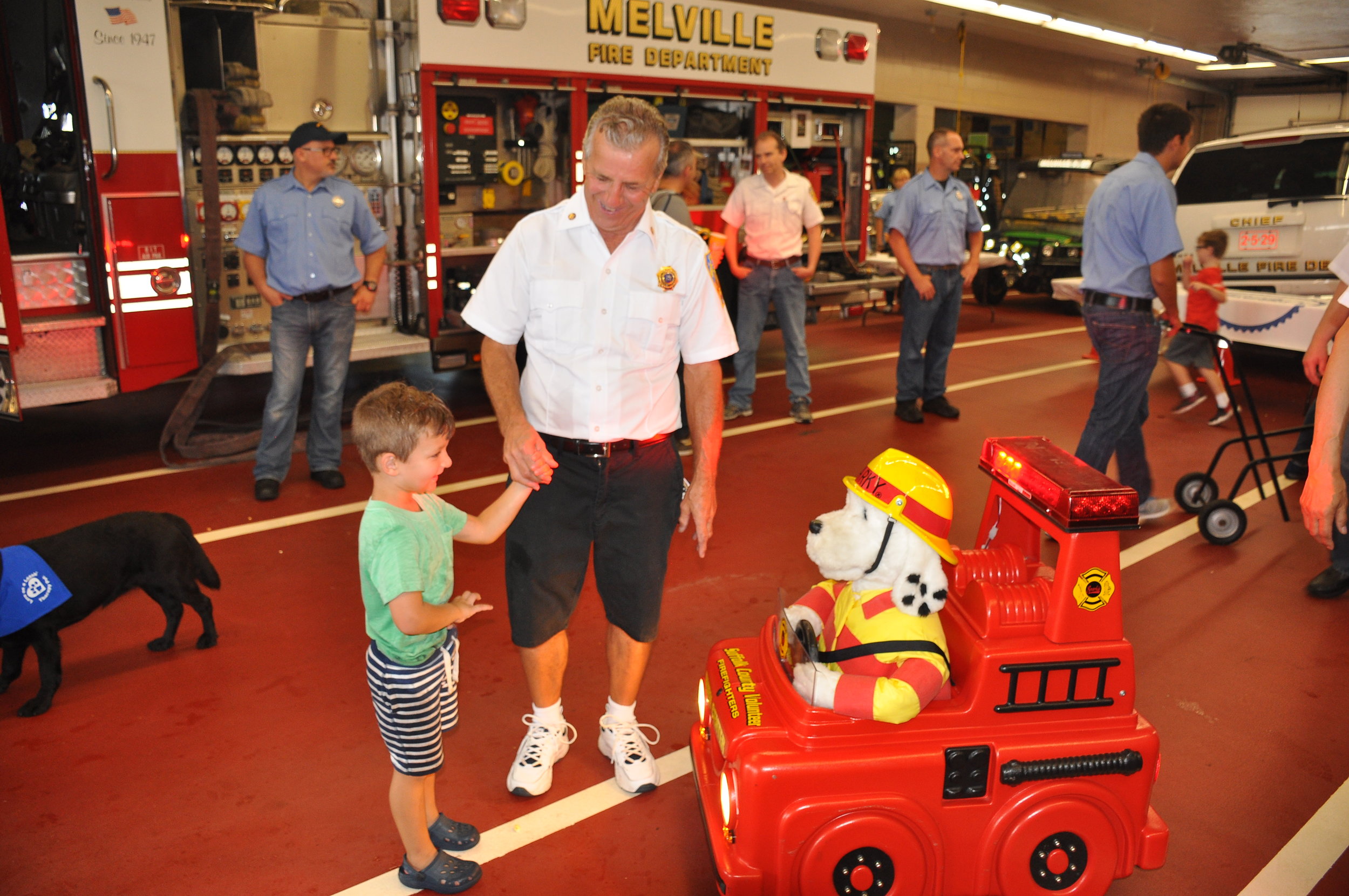   The open house drew hundreds, including families with children, who got to explore Melville fire headquarters.   Photo by Steve Silverman  