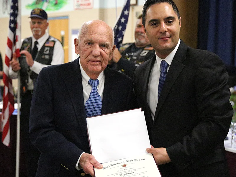   World War II veteran George Kunz, left, was presented with his high school diploma at 91 years old by South Huntington District BOE President Nicholas Ciappetta.&nbsp;  Photo by Steve Bartholomew  