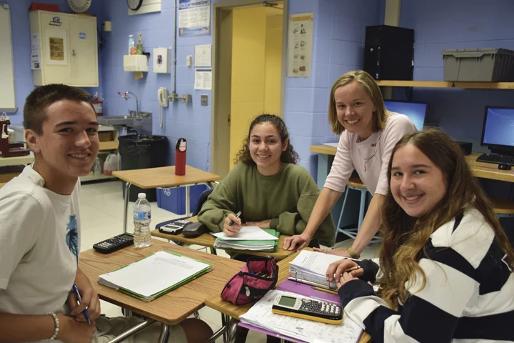 Kristen Rozell, second from right, a newly selected New York State Master Teacher, with her senior calculus students, from left, Joe Barry, Christina Wing, and Julianne Starzee. Photo Courtesy of Northport-East Northport School District