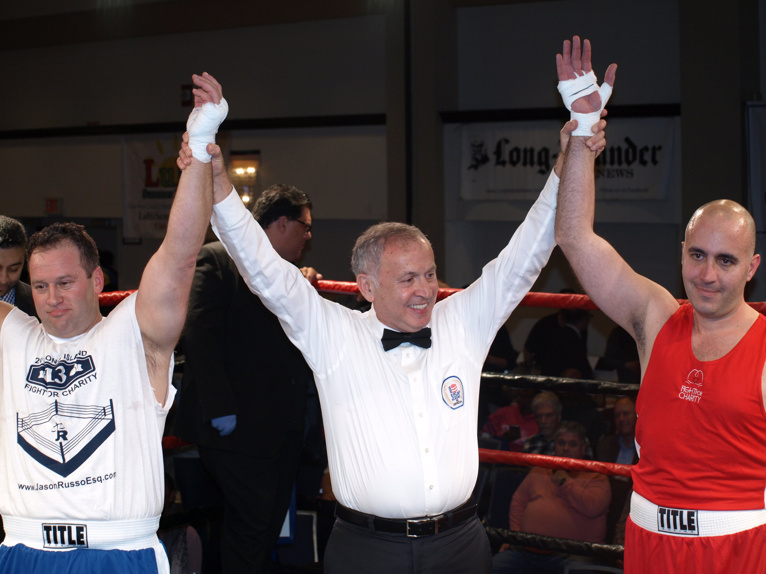   Eliud Custodio, of Huntington, right, and Jason Russo, of Bay Shore, both claim victory at the annual Fight For Charity.&nbsp;&nbsp;  Long Islander News Photo/Connor Beach  