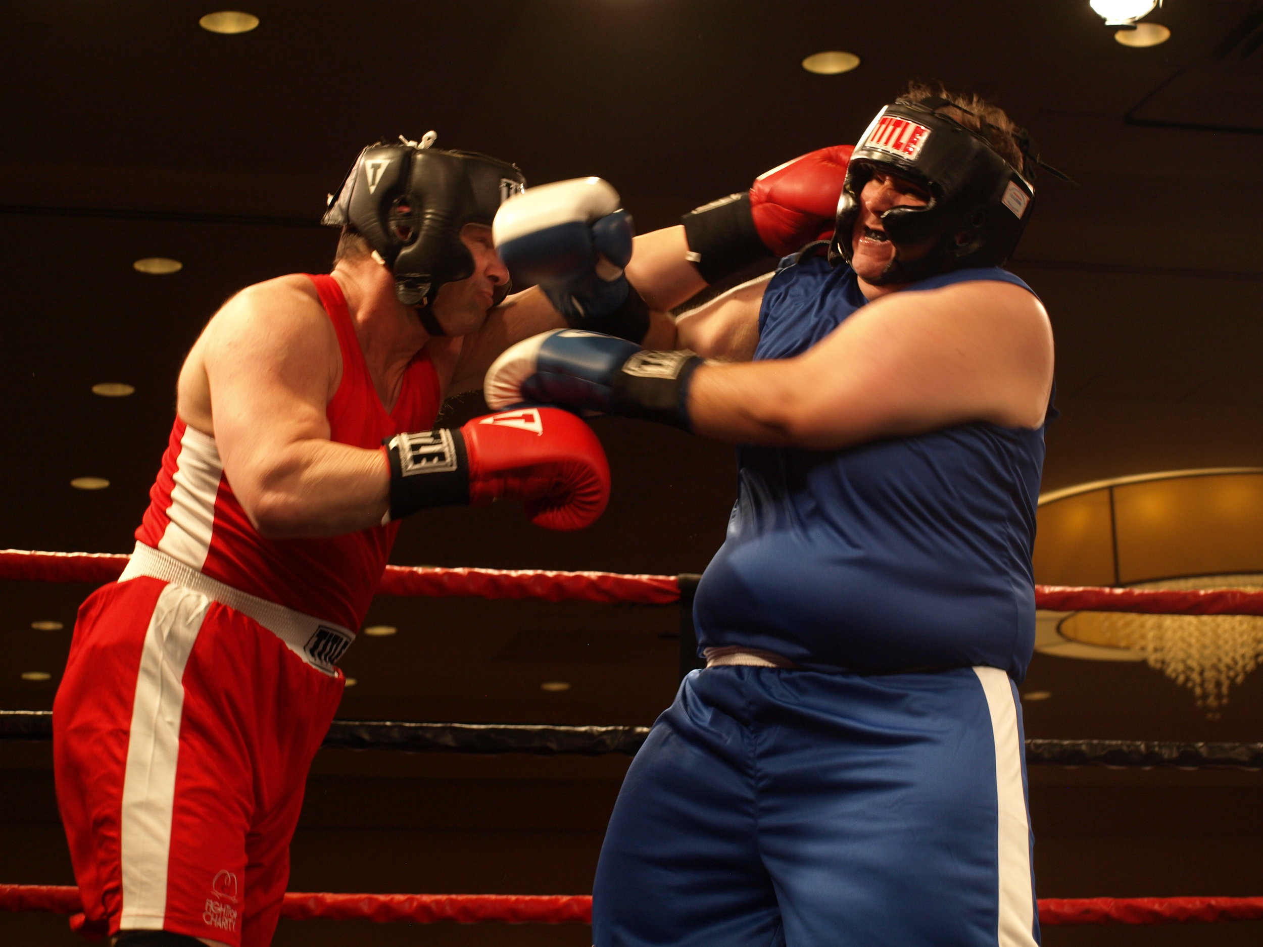   David “Double-Click” Tan, of Glenwood Landing, right, takes a punch from Billy “The Brawler” Lewis.   Long Islander News Photo/Connor Beach  