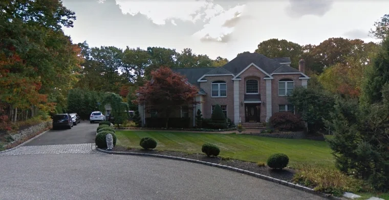 The Shoreham home where a Northport man died Saturday after the “ground gave way” during a cesspool installation, according to Suffolk police. Photo/Google Maps
