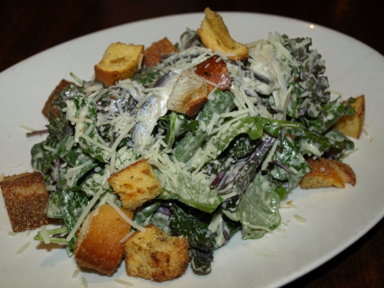   The Baby Kale Caesar ($14) is served with garlic croutons, Parmigiano-Reggiano cheese, marinated white anchovies and a Caesar dressing.&nbsp;  Long Islander News Photo/Connor Beach  