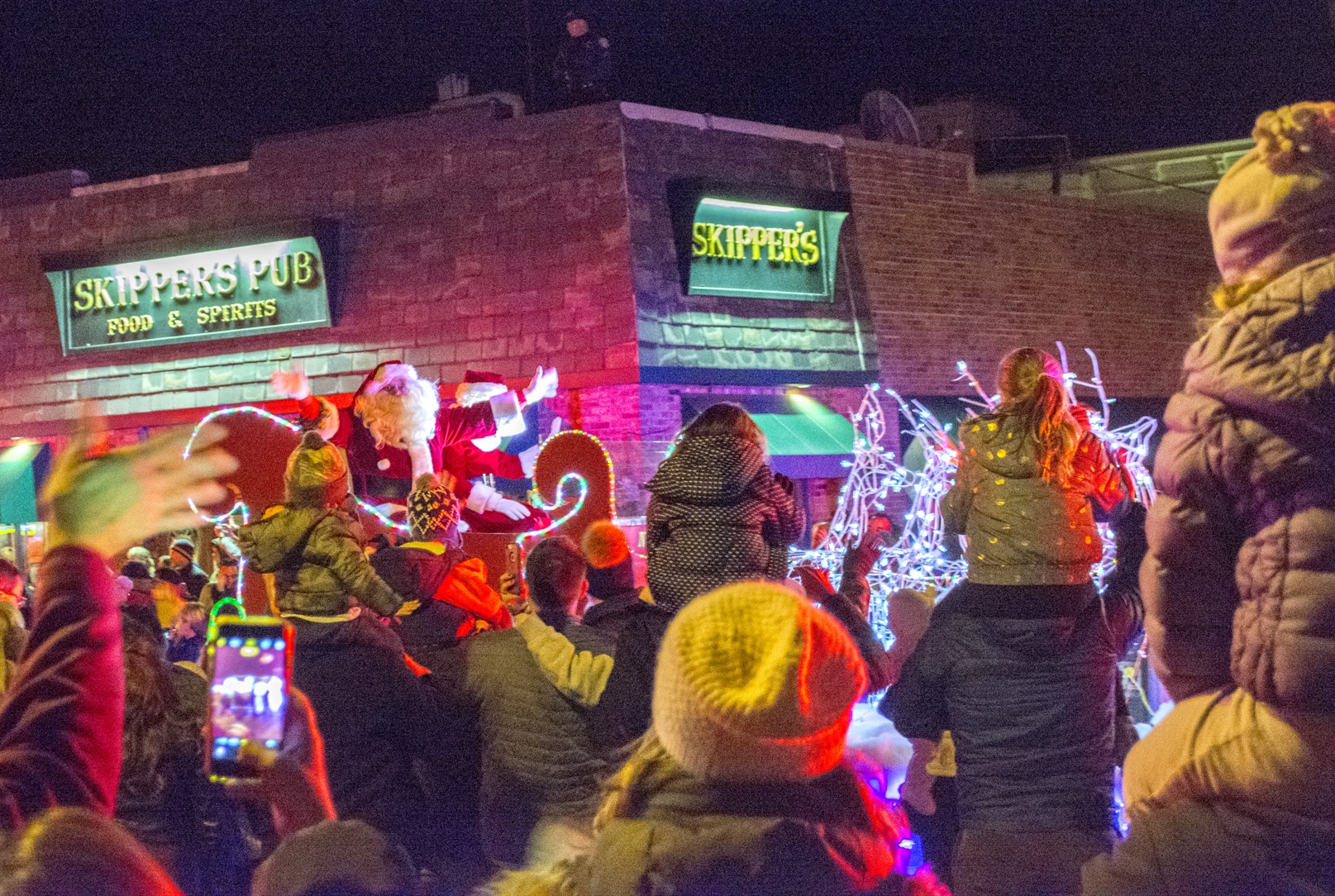Thousands hit the streets to welcome Mr. and Mrs. Claus to Northport Village on Friday. Long Islander News Photo/Andrew Wroblewski Long Islander News photos/Andrew Wroblewski