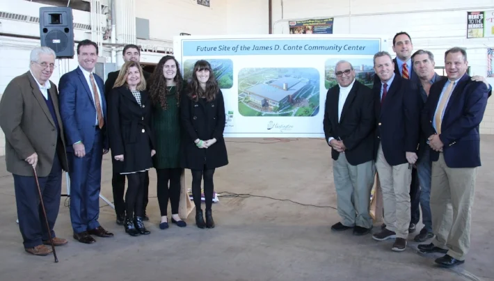 State and town officials, as well as members of the Conte family, unveil plans for what will be the Conte Community Center at the site of the New York State Armory in Huntington Station. Photo Courtesy of Town of Huntington