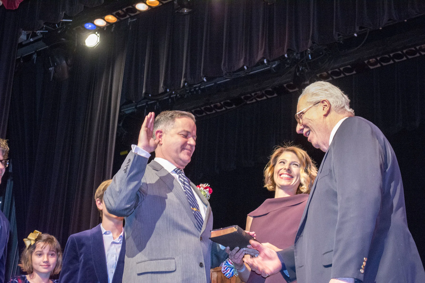   State Sen. Carl Marcellino (R-Syosset) administers the oath of office to Councilman Ed Smyth, whose wife Coriander and children Harlan, Edmund, Lily and Sarah look on.&nbsp; Long Islander News photos/Connor Beach   