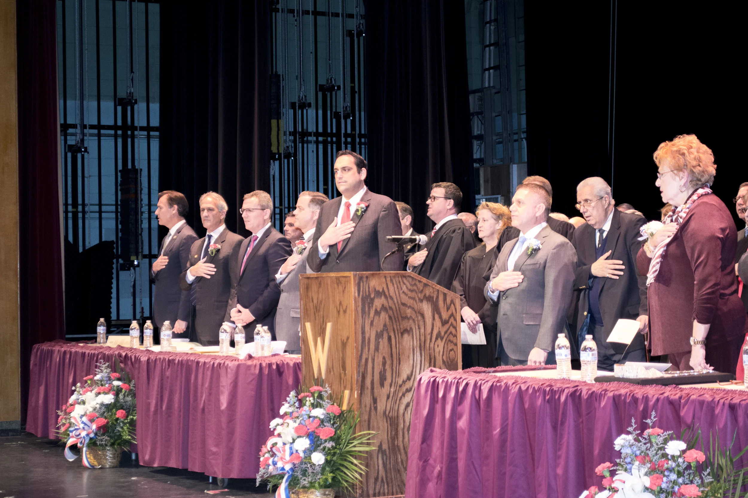   Huntington Supervisor Chad Lupinacci, fifth from left, stands for the Pledge of Allegiance alongside fellow elected town officials at Tuesday night’s inauguration ceremony.   Long Islander News Photos/Connor Beach     &nbsp;  