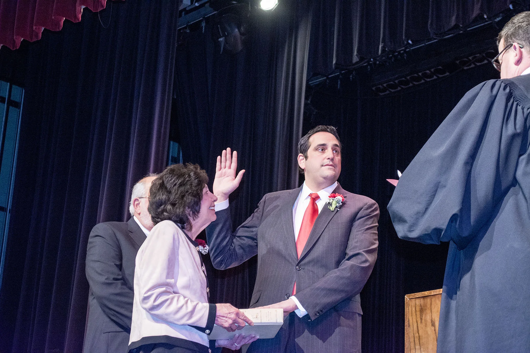   Taking the oath of office Tuesday night is Huntington Supervisor Chad Lupinacci, who is flanked by his parents Susan and Sal Lupinacci.&nbsp;   Long Islander News Photos/Connor Beach     &nbsp;  