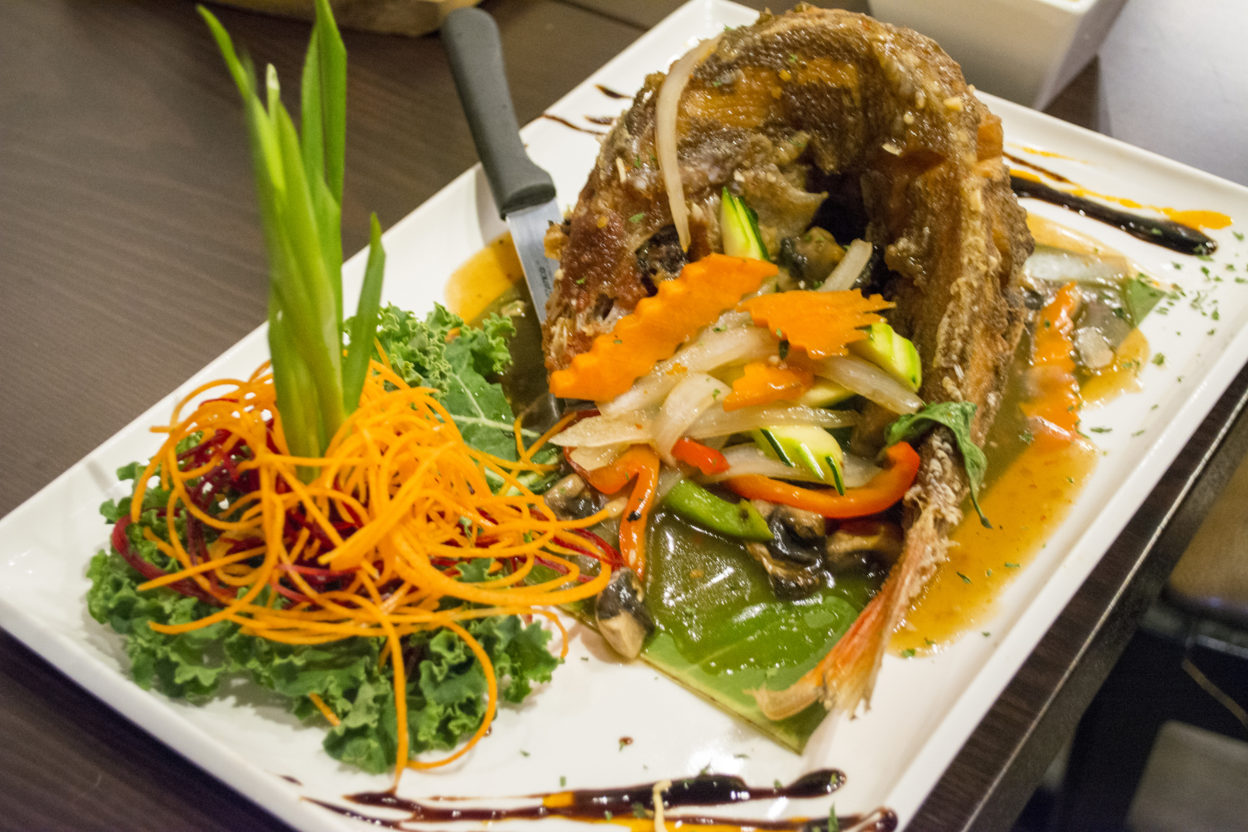 For seafood lovers Tum Thai offers Pla Kra Prow ($23.95) that features red snapper served whole, cooked to a crispy golden brown and topped with chili and Thai basil sauce. Long Islander News photos/Connor Beach