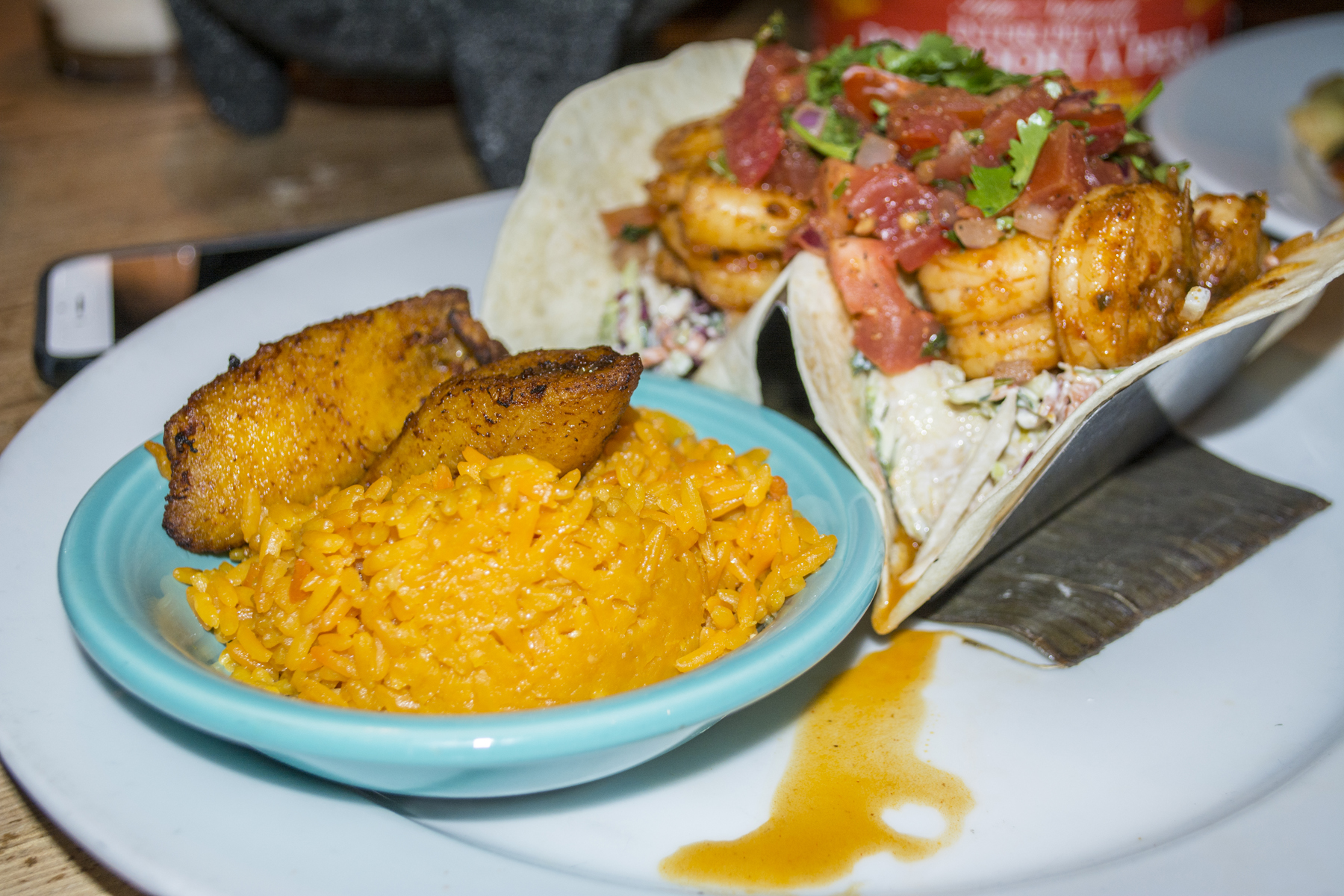   The Angry Shrimp Tacos ($13.95) feature spicy shrimp served with vegetable citrus slaw, lime, margarita crema, Spanish rice and plantains.   Long Islander News photos/Barbara Fiore           