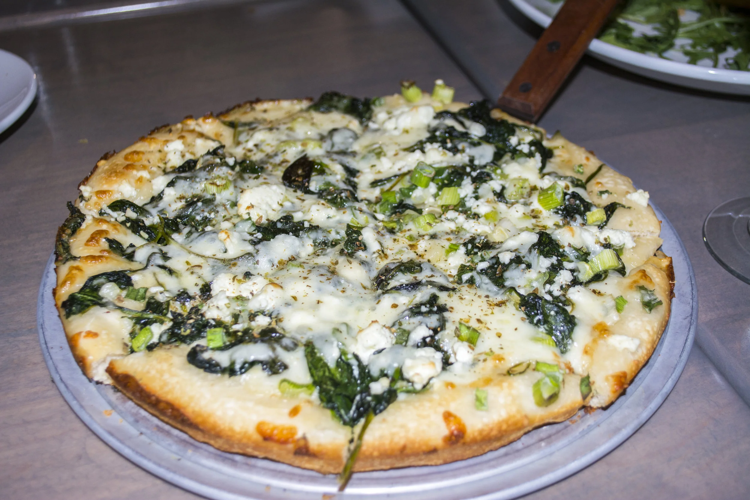 The Spanakopita Pie ($14) is topped with spinach, scallion, mozzarella, ricotta, feta and dill. Long Islander News photos/Connor Beach