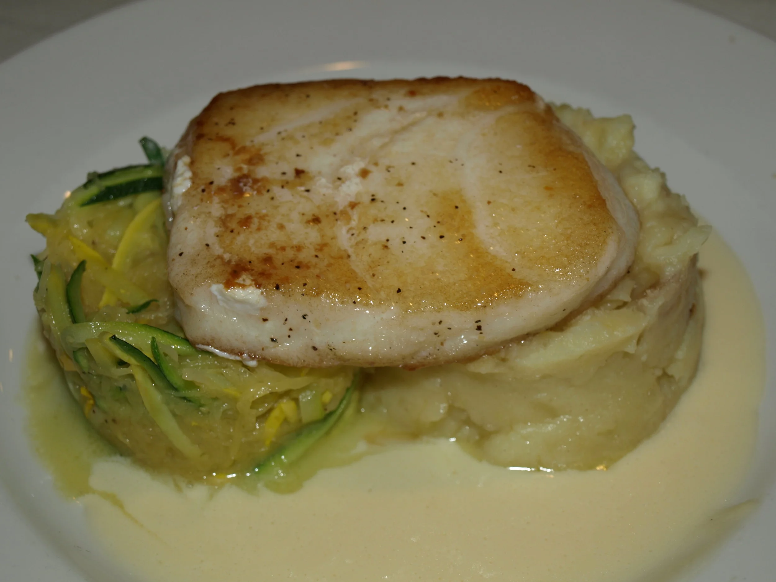   The Chilean Sea Bass ($34) is served with a chardonnay buerre blanc sauce, whipped potatoes, julienne zucchini and spaghetti squash.   Long Islander News photos/Connor Beach     