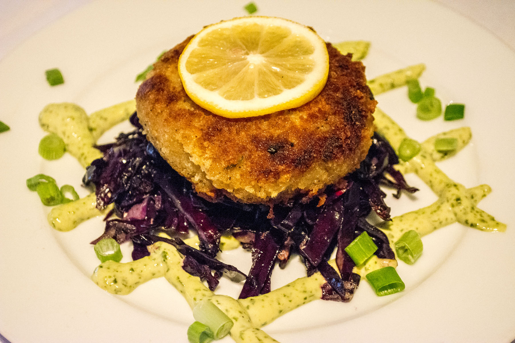 The Torta de Cangrejo ($13) is a jumbo lump crab cake tossed in panko breadcrumbs and served with basil aioli and sautéed red cabbage. Long Islander News photos/Connor Beach