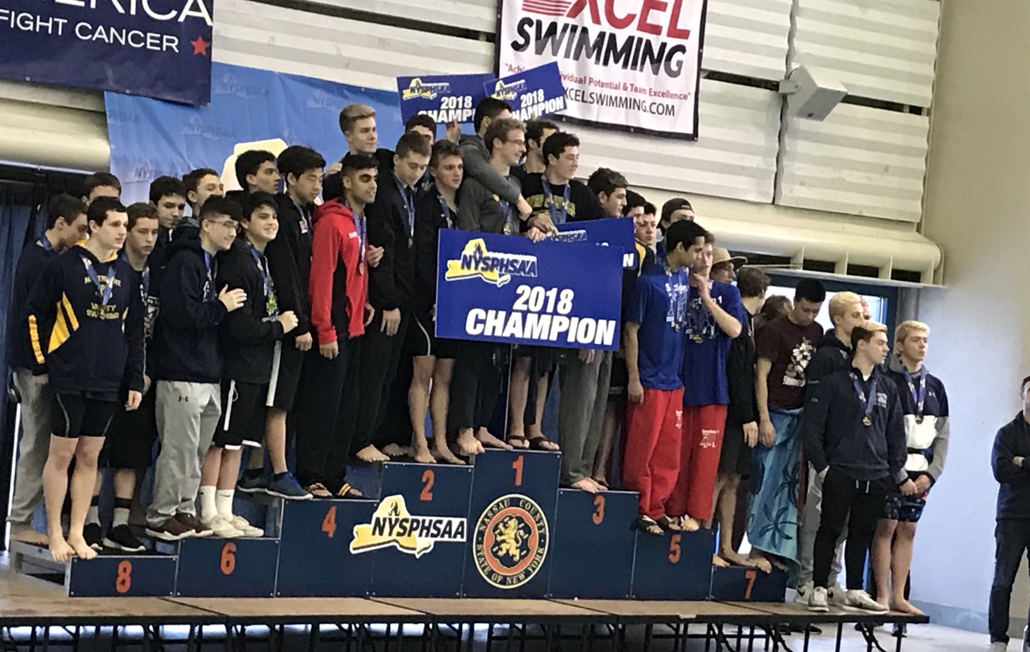   The Half Hollow Hills 200-yard medley relay team of Mason Arnberg, Dylan Chan, Kabir Randhawa and Ethan Tack stand in the fourth-place slot of the podium at the state championships last weekend.  &nbsp; Photo/Twitter  