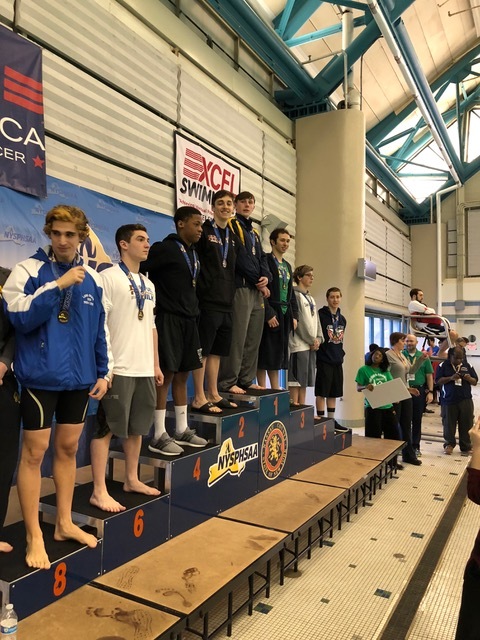   Ethan Tack stands in second on the podium for his performance in the 100-yard butterfly.   Photos courtesy of Nina Cunningham  