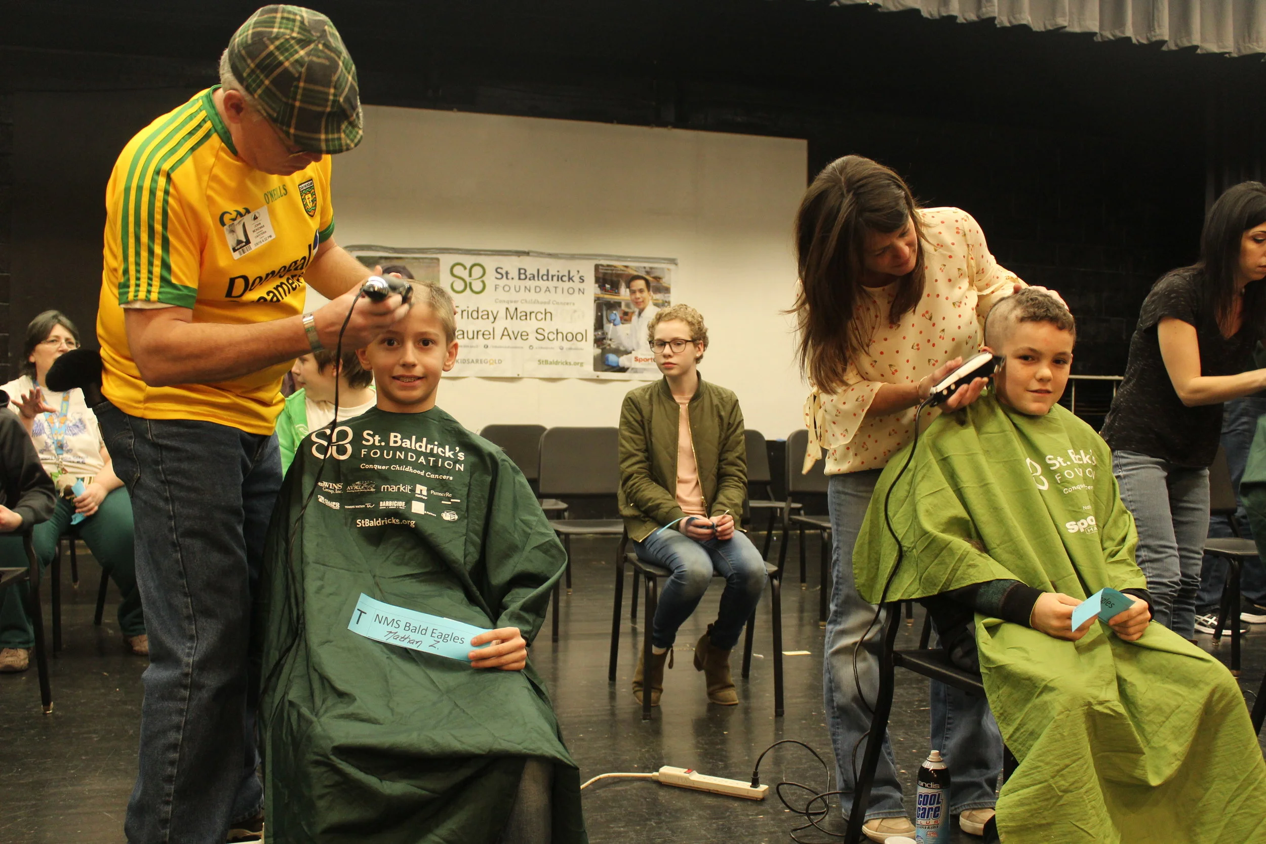   Northport Middle School students have their heads shaved to raise money for the St. Baldrick’s Foundation, formed to raise money to research cures for cancers affecting children.   Photo/Northport-East Northport School District  