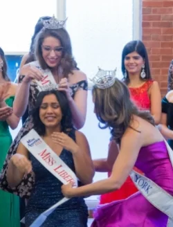 Inpreet Rattu, seated, is crowned Miss Liberty 2018. Photo courtesy of Paul Klecka