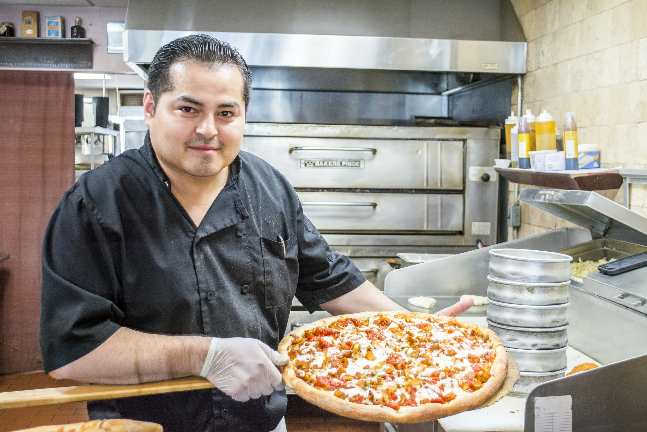   Owner Donaldo Escobar reopened Fattusco’s three months ago and has since been serving up chicken parm pizza, pictured, and other delicious Italian favorites.   (Long Islander News photos/Sophia Ricco)  