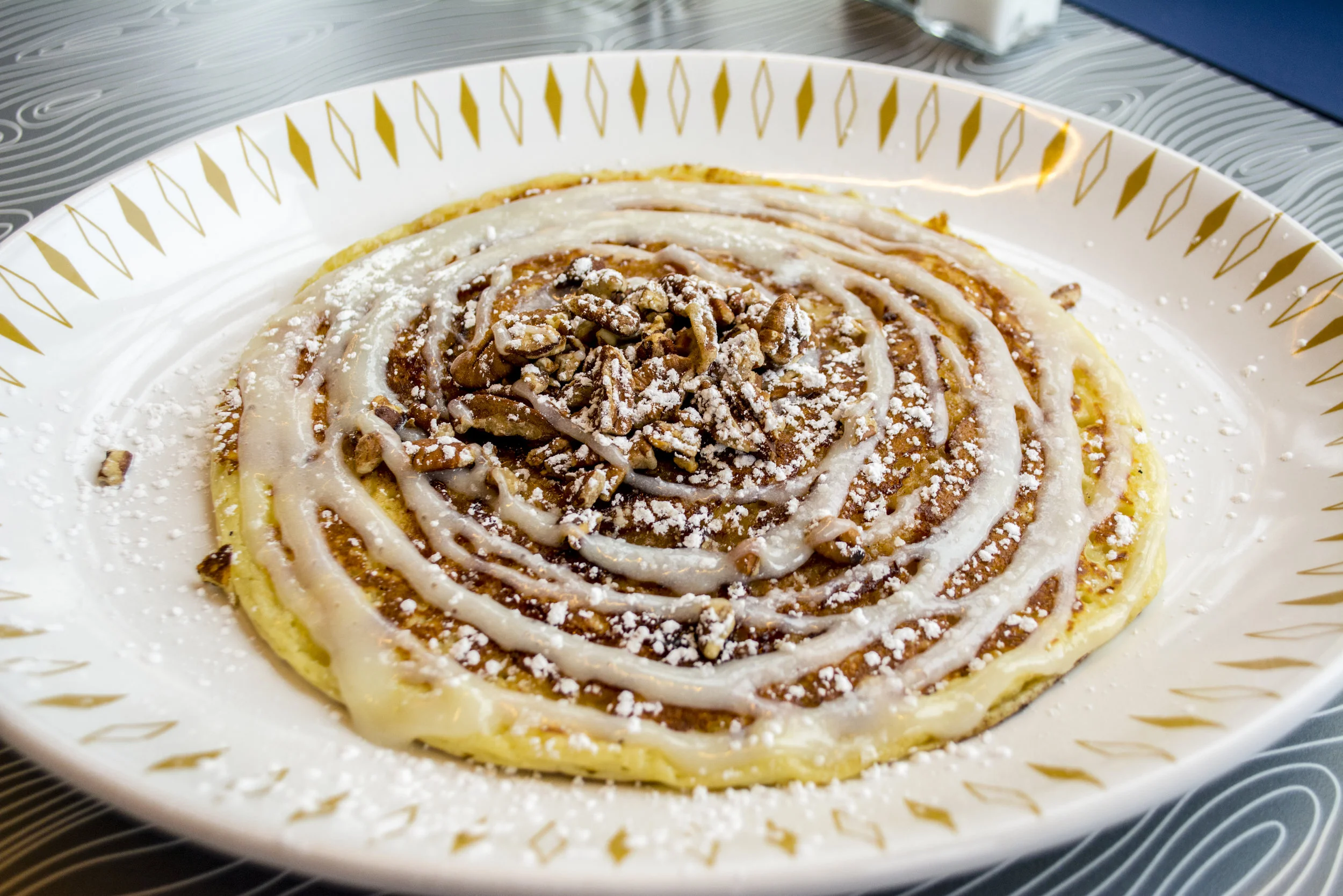  Hatch’s Cinnamon Roll Pancakes ($5.25/one; $8.75/two) are packed with a creamy butter pecan filling and topped with cream cheese glaze and toasted pecans.  