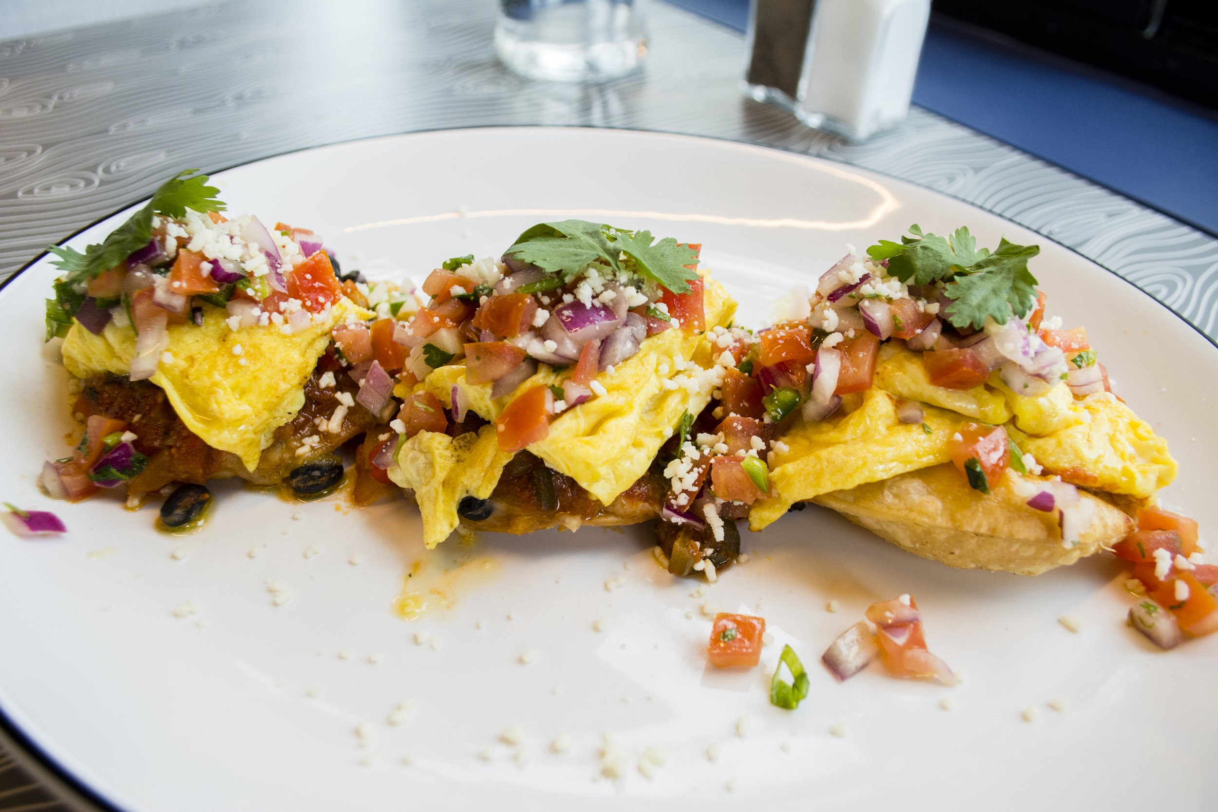   The Huevos Rancheros ($11.25) starts with crisp corn tortillas layered with black beans, jack cheese, ranchero sauce, three eggs any style, salsa fresca and cotija cheese.  