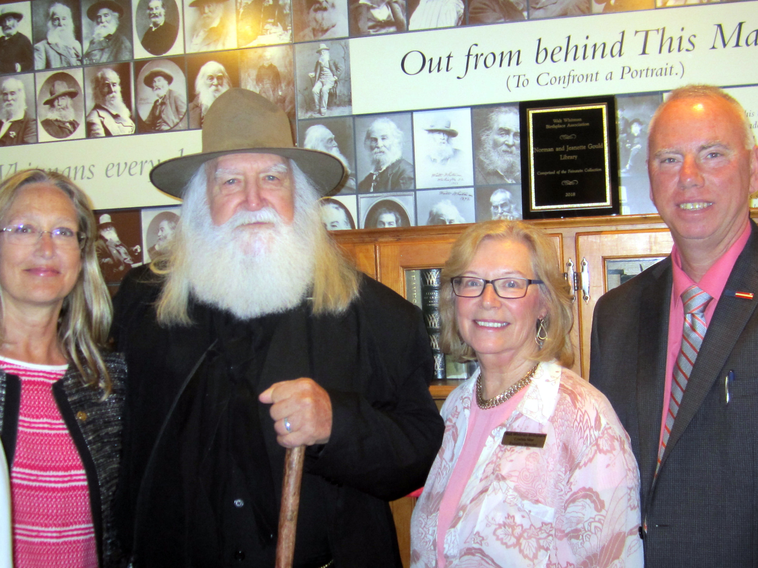   Suffolk Legis. Tom Donnelly, right, attended the dedication last Thursday. He’s pictured, from left, with: Suffolk Legis. Bridget Fleming; Whitman personator Darrel Blaine Ford; and Birthplace Executive Director Cynthia Shor.   (Photo/Office of Leg