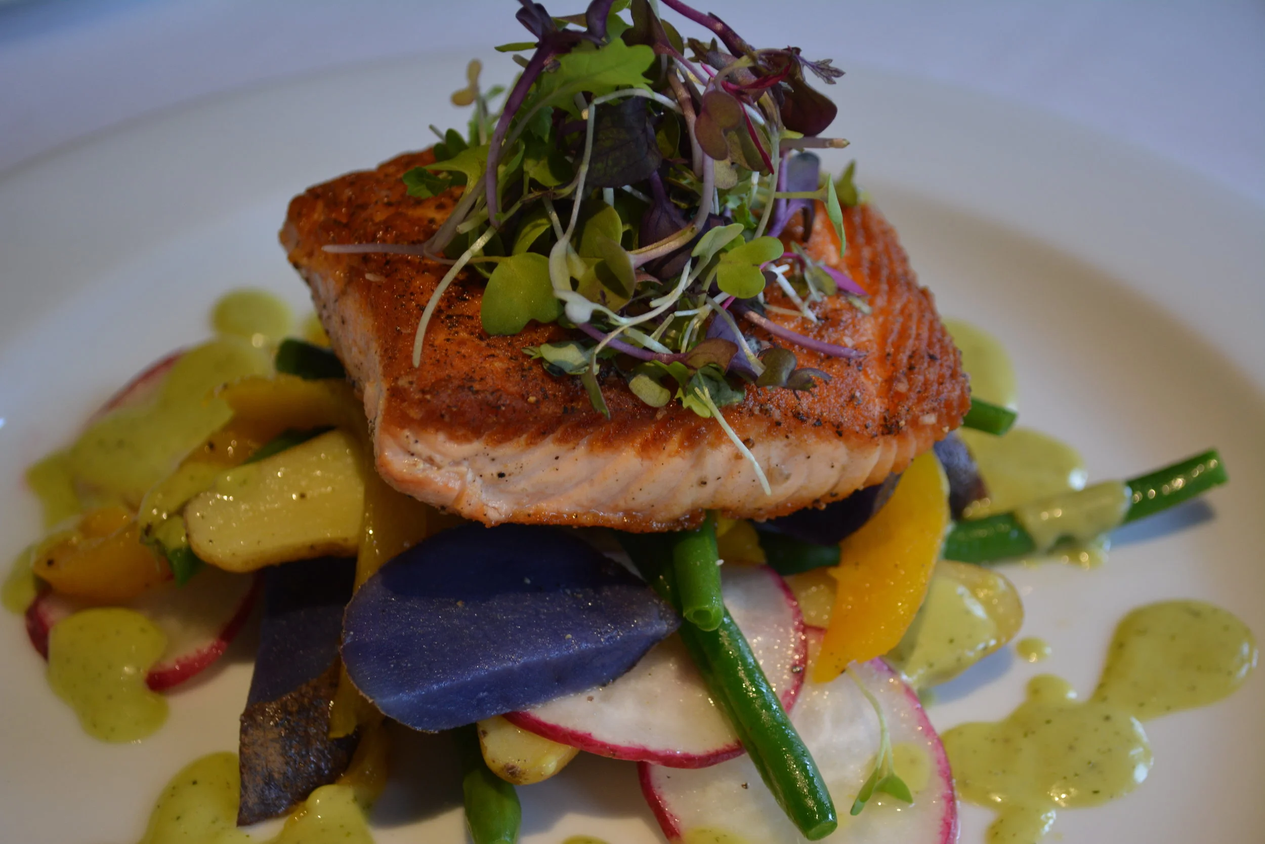  Salmon ($28) is served with a heirloom potato and string bean salad and a dill vinaigrette. 