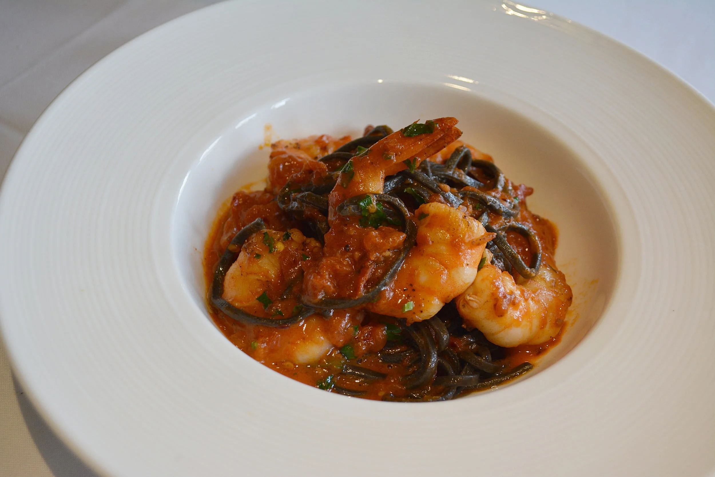  Linguine Nere featuring squid ink linguini, shrimp, and a spicy Marzano tomato sauce, is also new for spring. 
