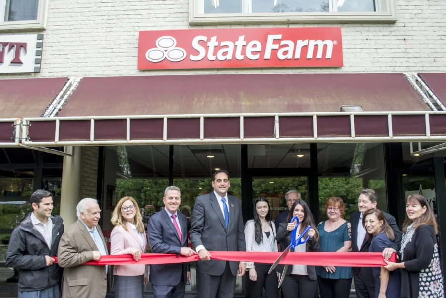 At the ribbon cutting ceremony last week, Huntington Supervisor Chad Lupinacci, left-center, and town council members Joan Cergol and Mark Cuthbertson, second and third from left, are pictured with Huntington Chamber of Commerce board and staff and Kelly Schumacher, pictured center with her team, at her new State Farm Agency in Huntington.