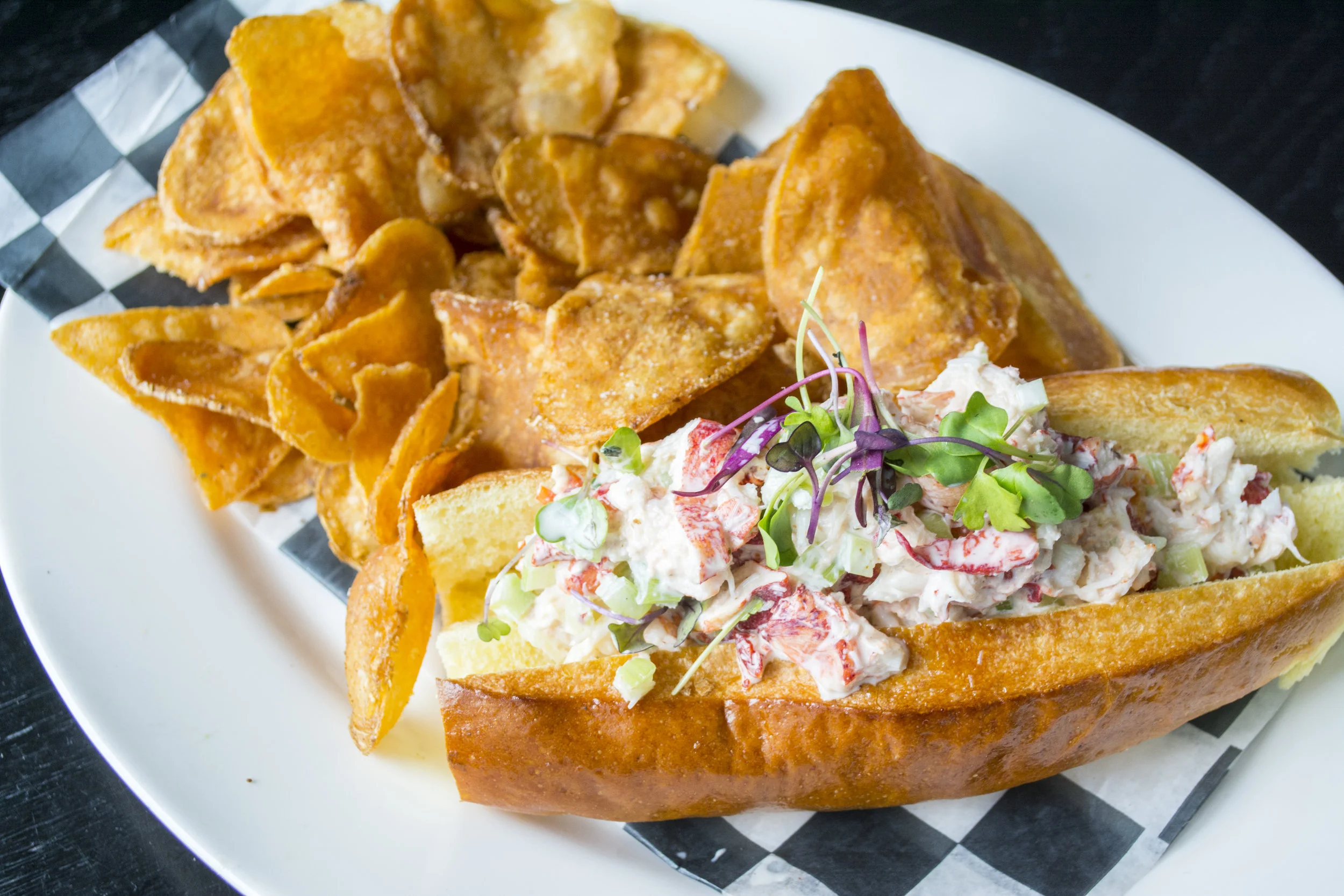   Finley’s Lobster Roll ($22) is served on a brioche-style roll with lemon mayo, celery and old bay potato chips.  