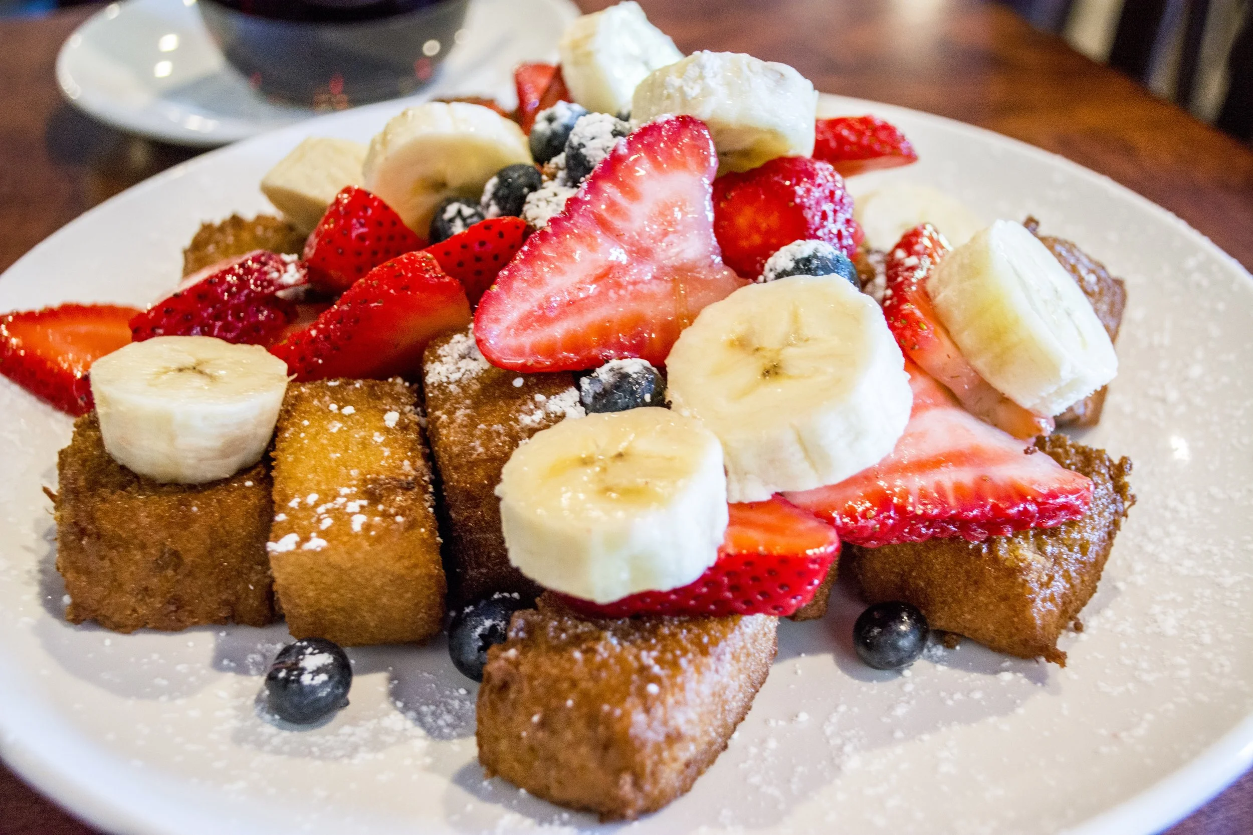   French Toast Bites ($9.99) are topped with fresh berries, bananas, strawberries and powdered sugar.  