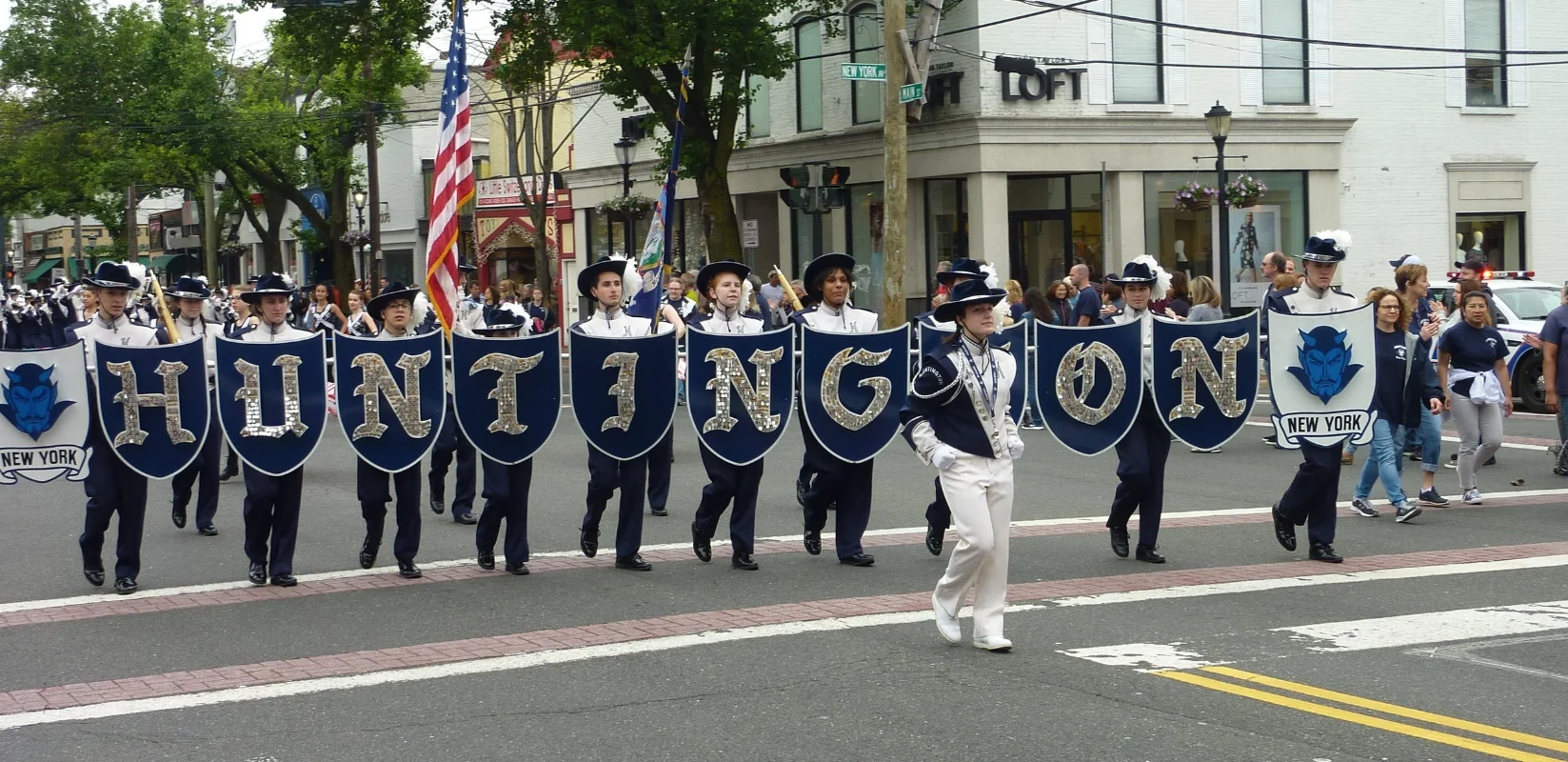   Huntington High School’s Blue Devil Marching Band played patriotic tunes on the march through Huntington Village.  