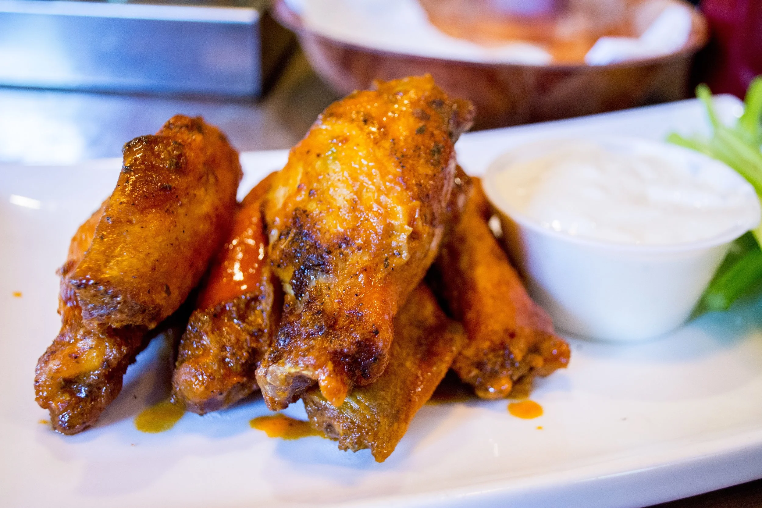   Buffalo Wings ($8 for six), ordered medium, pack a moderate level of spice that didn’t overpower the taste of the well-seasoned chicken.  