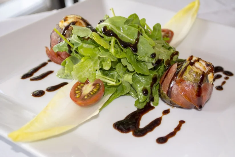   Stuffed Figs ($16) are packed with goat cheese, wrapped in prosciutto and served on a bed of baby arugula with a balsamic drizzle.  