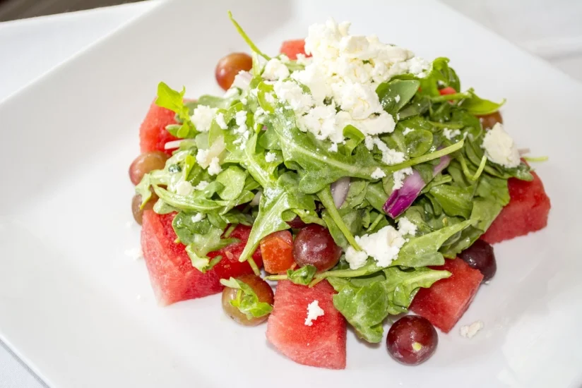  Watermelon Salad ($13) features watermelon, baby arugula, grapes, red onion, feta cheese and citrus vinaigrette.    